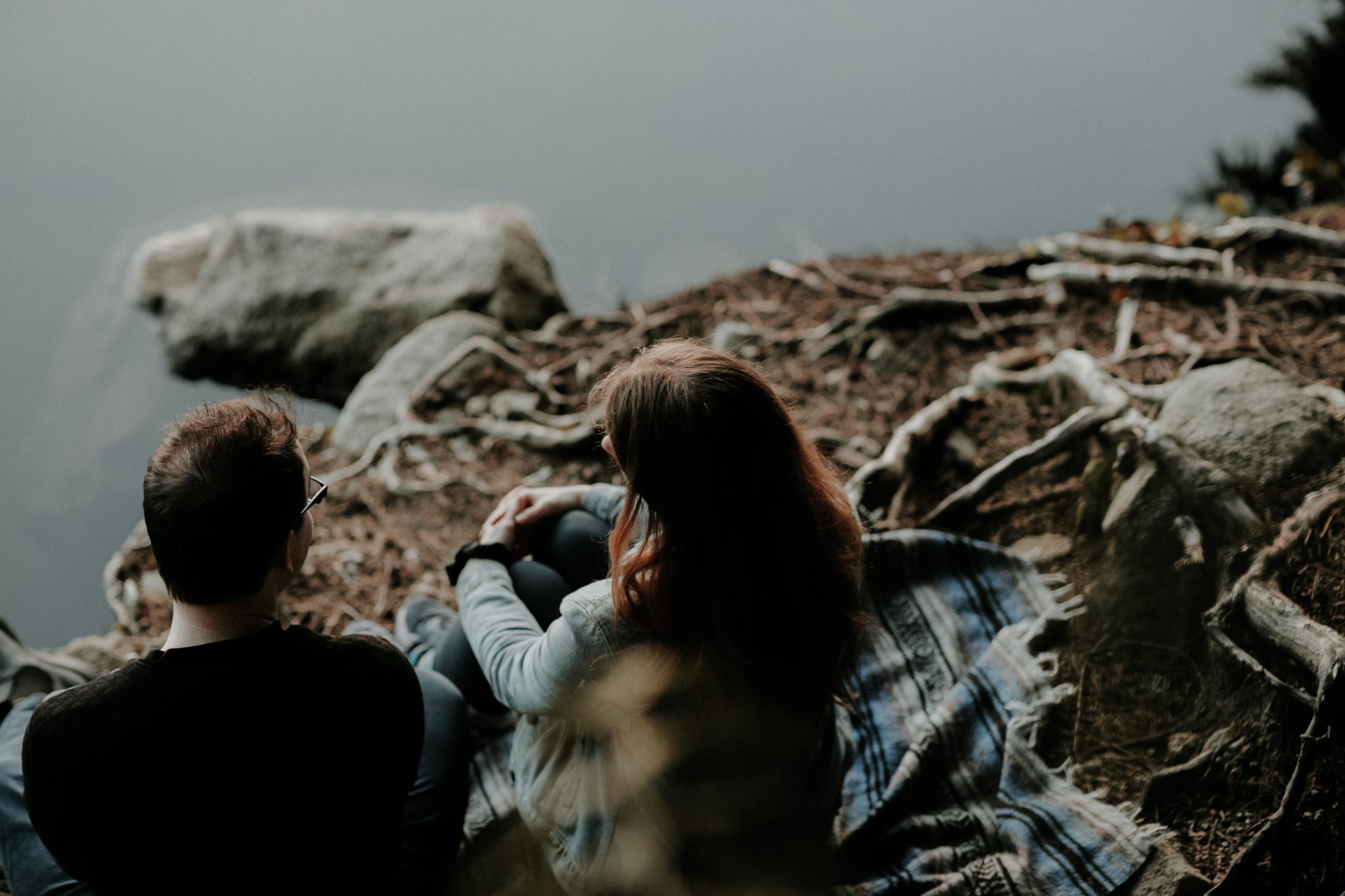 couple-sitting-by-lake