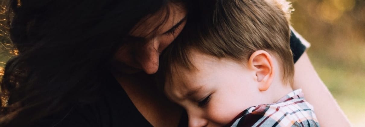 mom comforting child with storm anxiety