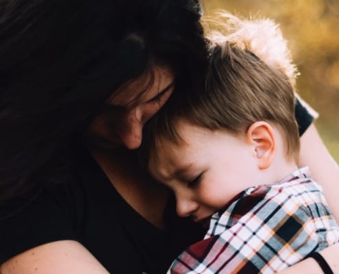 mom comforting child with storm anxiety