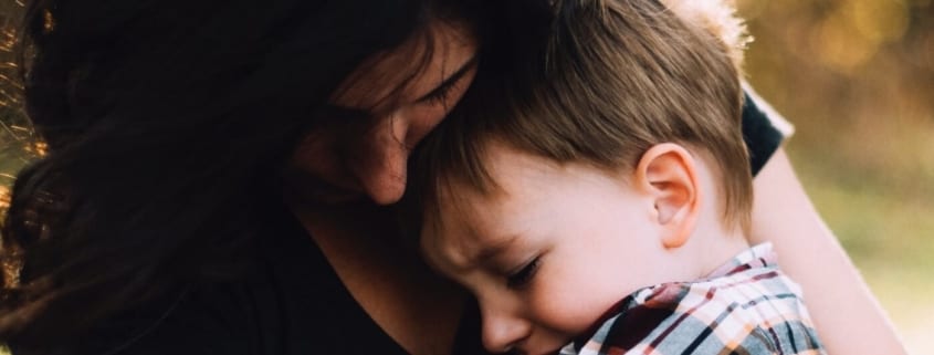 mom comforting child with storm anxiety