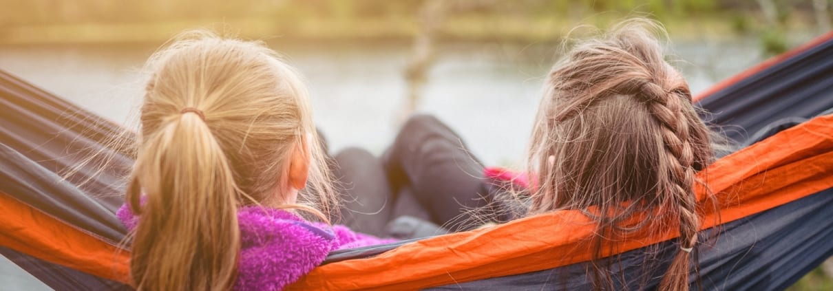 kids enjoying quiet time in hammock