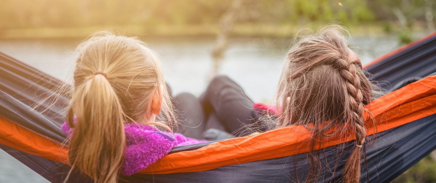 kids enjoying quiet time in hammock