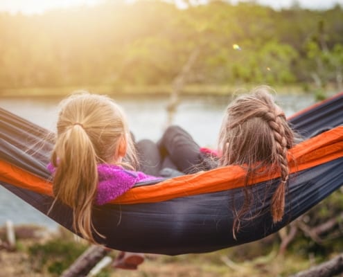 kids enjoying quiet time in hammock
