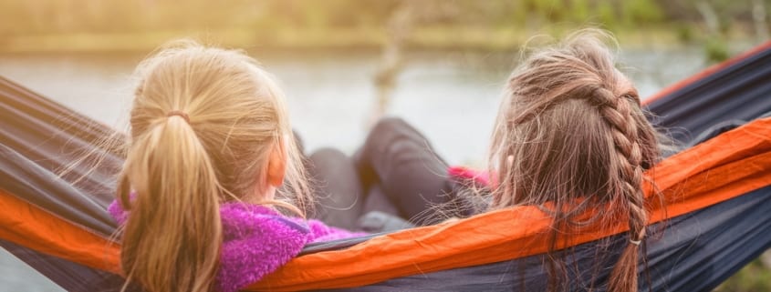 kids enjoying quiet time in hammock