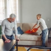 father and son cleaning house