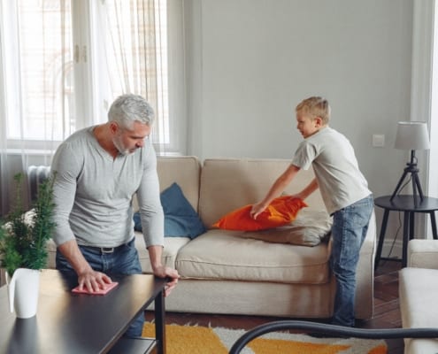 father and son cleaning house