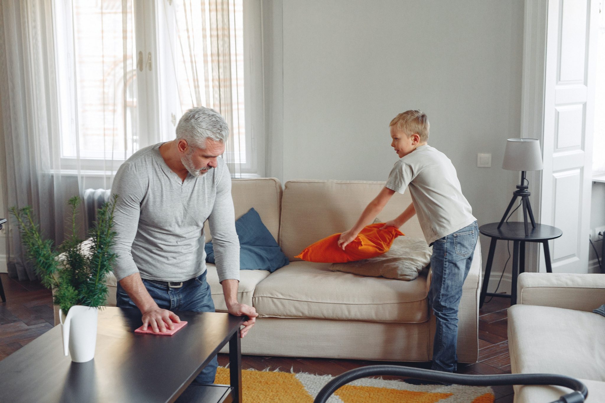 father and son cleaning house