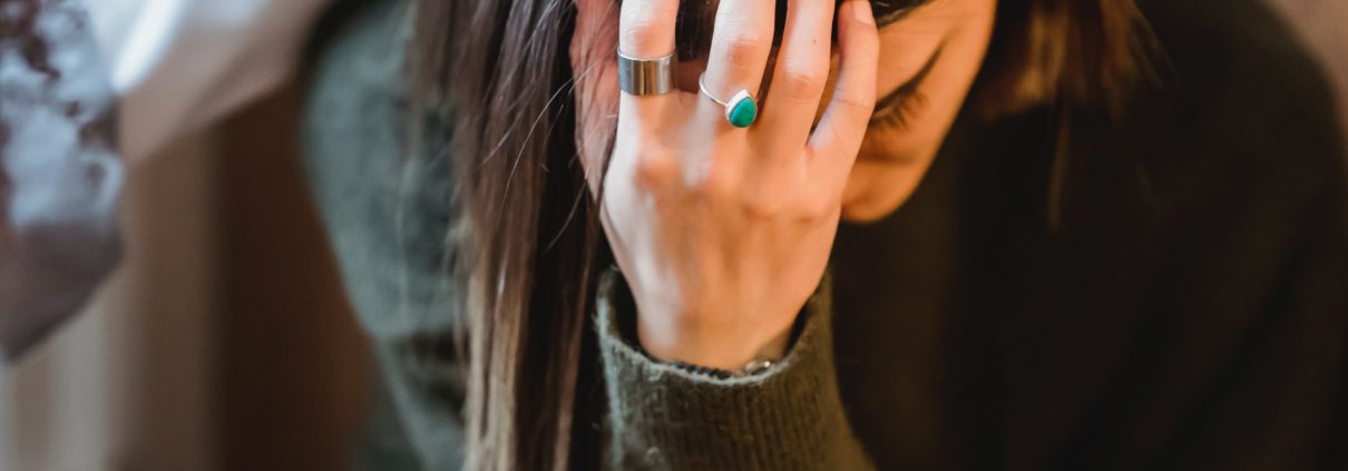 sad woman with hand on head