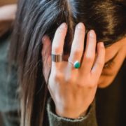 sad woman with hand on head