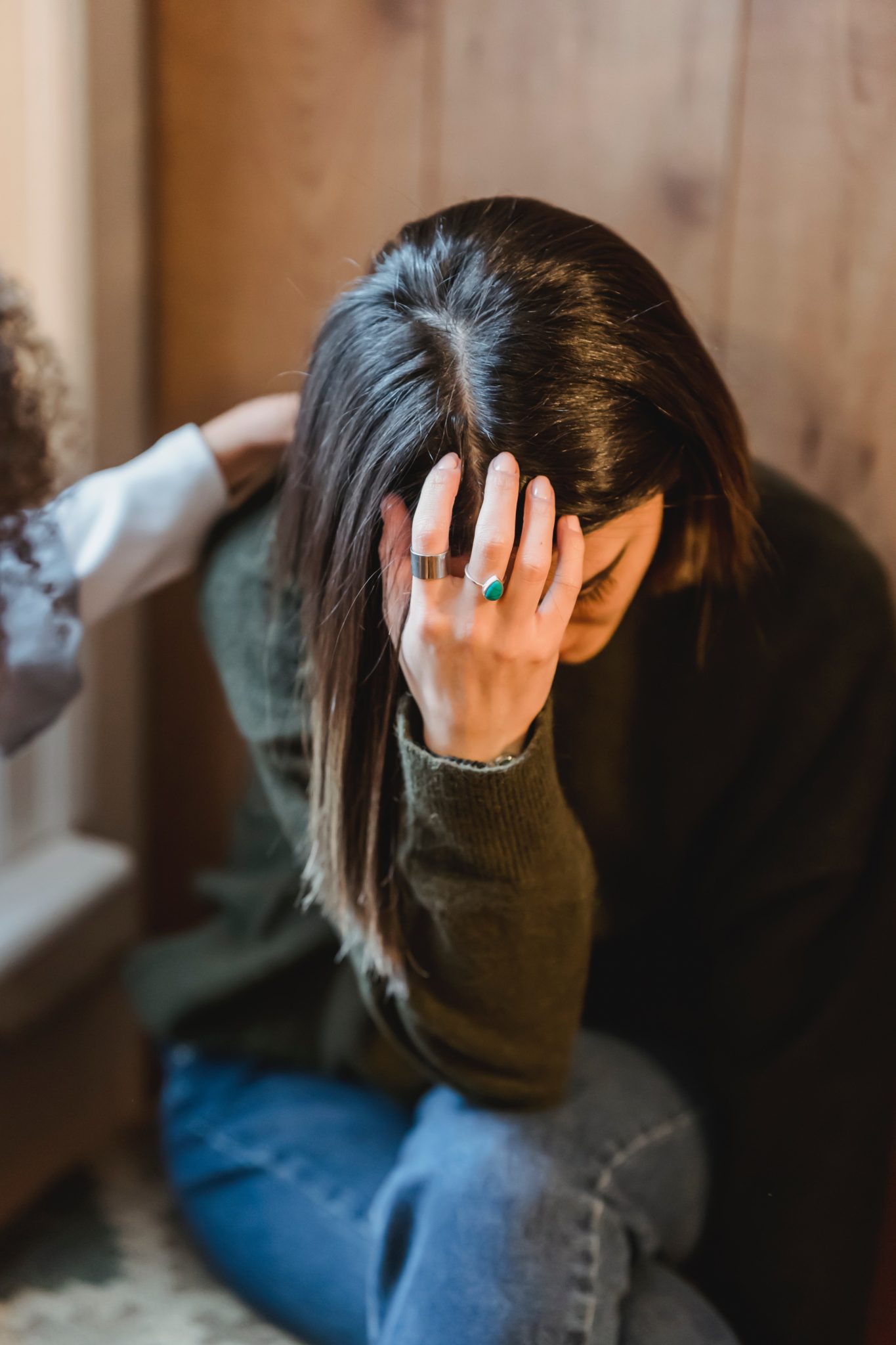 sad woman with hand on head