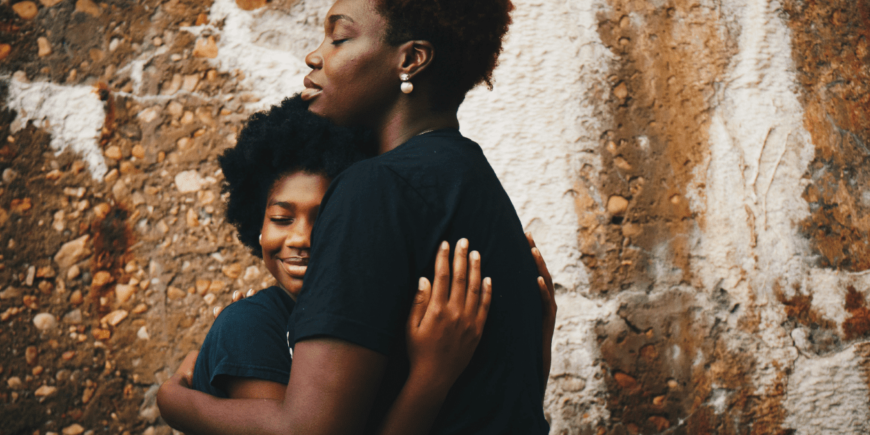 Hugging mother and daughter