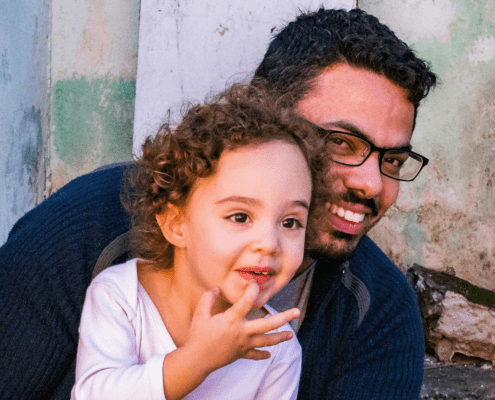 dad and daughter smiling