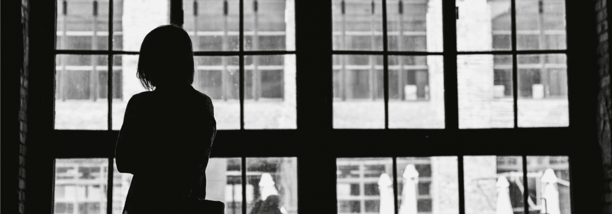 Sad woman looking out a window