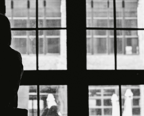 Sad woman looking out a window