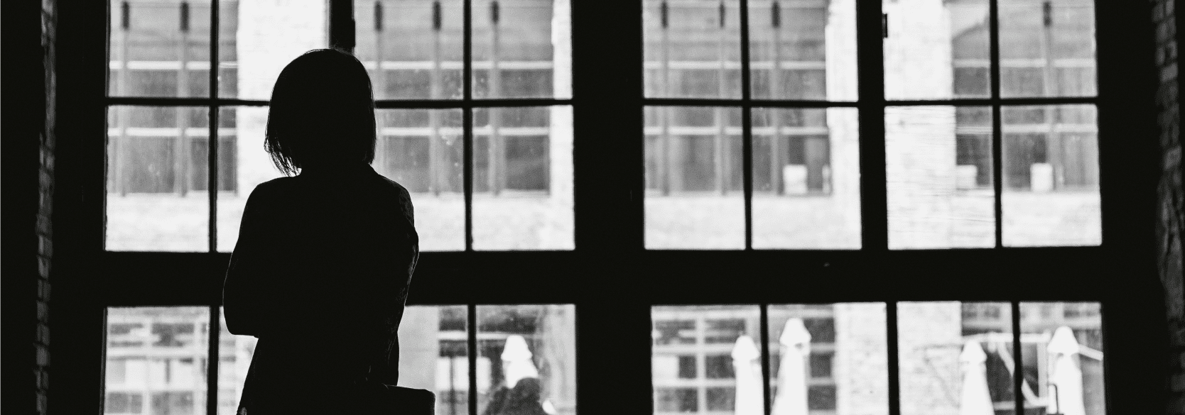 Sad woman looking out a window